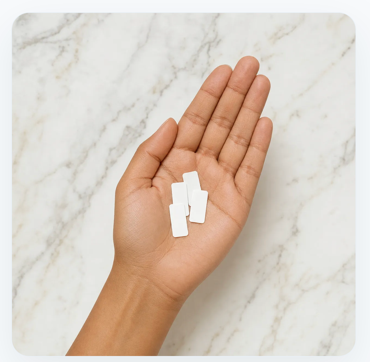 Doselets in hand on marble background